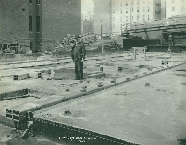 John B. McDonald standing on the Substation No. 14 building foundation, 1903.